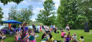 Image of family friendly drag show at Potsdam Pride festival with Amber Skyy performing as wonder woman